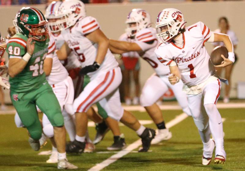 Ottawa quarterback Mark Munson looks to run the ball as L-P's Nick Hachenberger eyes him down on Friday, Sept. 13, 2024 at Howard Fellows Stadium.