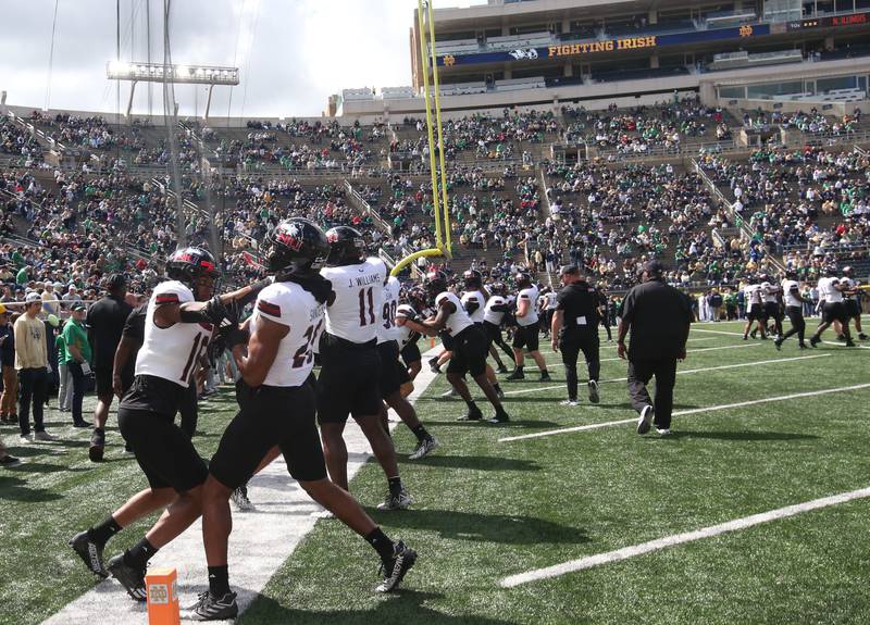 Members of the NIU football team warm up against Notre Dame on Saturday, Sept. 7, 2024 at Notre Dame Stadium.