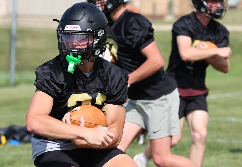 Sycamore’s Dylan Hodges carries the ball in a drill Monday, Aug. 12, 2024, during the first practice of the regular season.