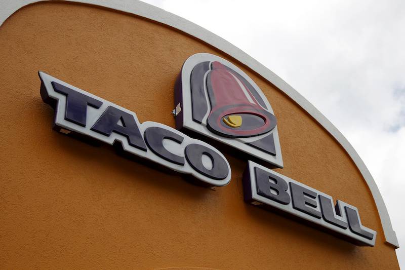 FILE - This Friday, May 23, 2014, file photo shows a sign at a Taco Bell in Mount Lebanon, Pa. Taco Bell and Pizza Hut say they're getting rid of artificial colors and flavors, making them the latest big food companies scrambling to distance themselves from ingredients people might find unappetizing. (AP Photo/Gene J. Puskar, File)