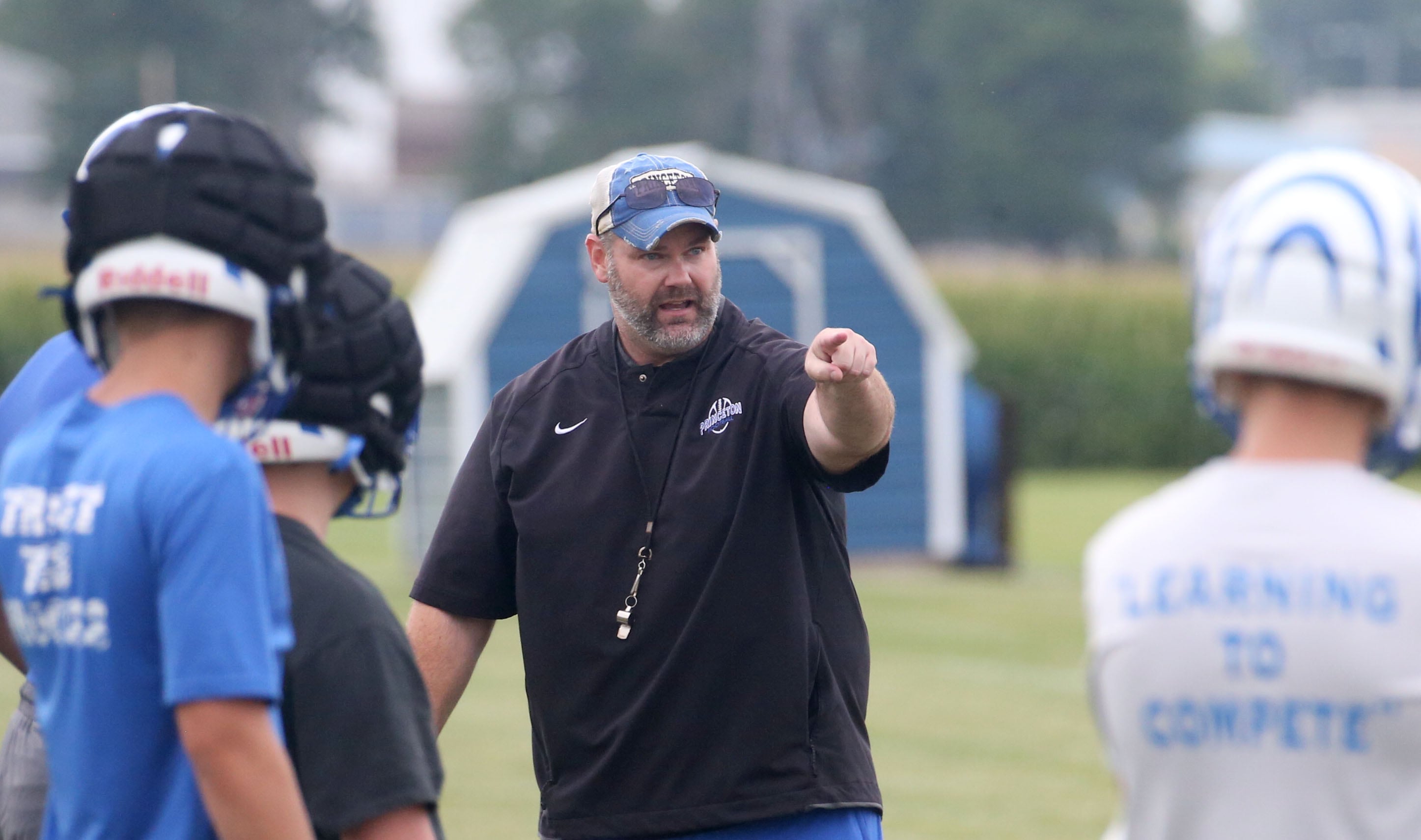 Princeton head coach Ryan Pearson talks to his team as they run drills during the first day of football practice on Monday, Aug. 12, 2024 at Little Siberia Field in Princeton.