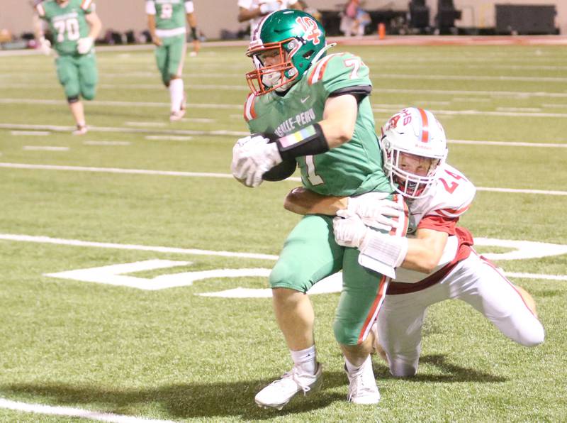 L-P's Walter Haage runs with the ball as he is brought down from behind by Ottawa's Weston Averkamp on Friday, Sept. 13, 2024 at Howard Fellows Stadium.