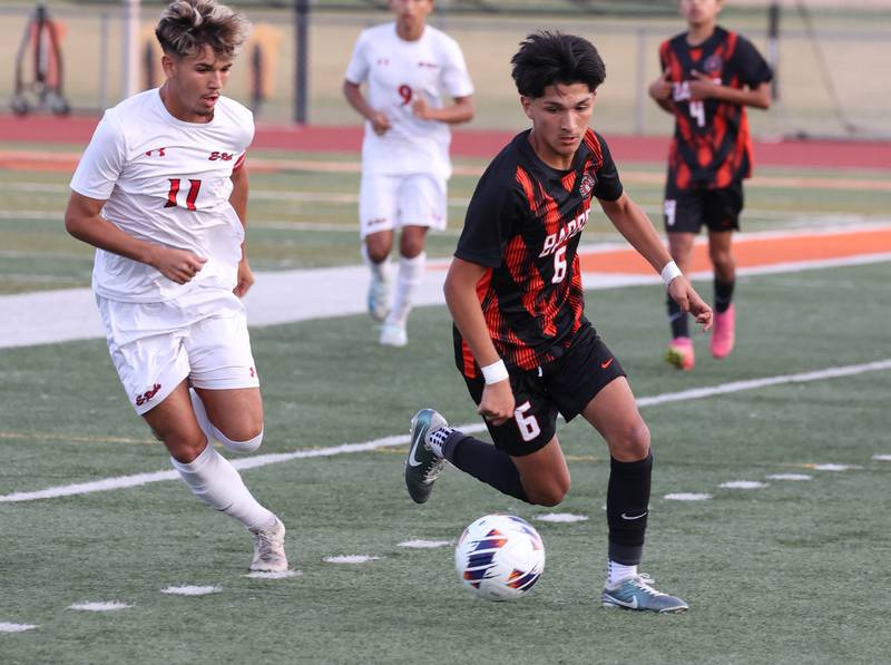 DeKalb's Mauricio Jasso (right) tries to avoid Rockford East's Jovanni Ortega Cardenas during their game Thursday, Sept. 12, 2024, at DeKalb High School.