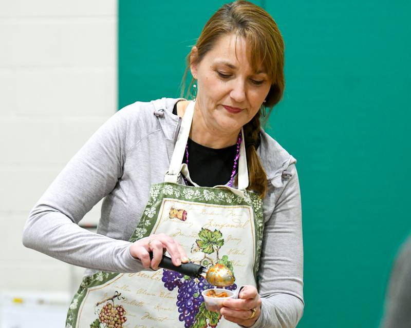 Michelle Donahoe of the DeKalb County History Center dishes out chili during the Sycamore Park District's Fire and Ice Festival held at the Sycamore Park District Community Center on Saturday, Jan. 13, 2024.