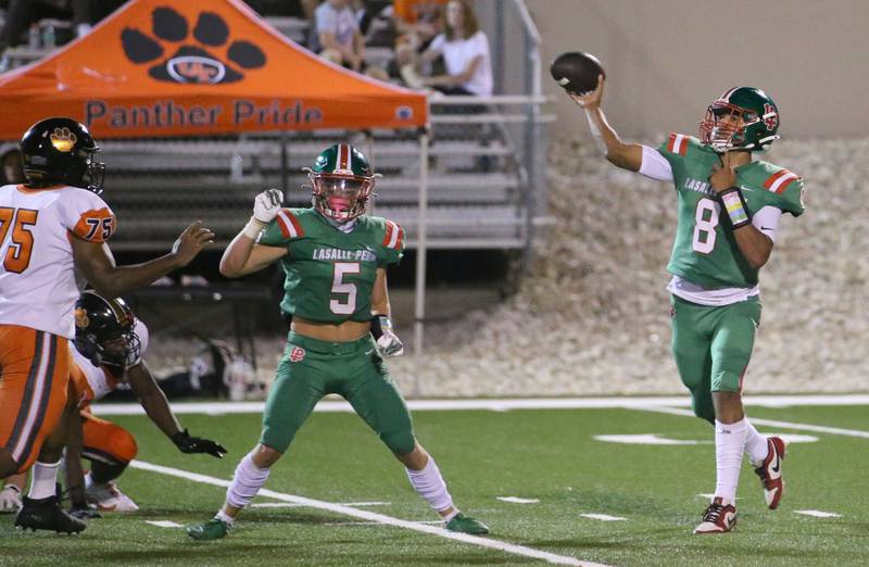 L-P quarterback Marion Persich throws a pass as teammate Brevyn Vogel blocks United Township's Riley King on Friday, Aug. 30, 2024 at Howard Fellows Stadium.