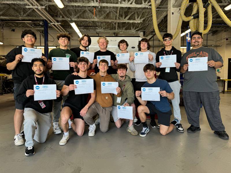 Lockport Township High School advanced auto shop students hold up their ASE certifications.