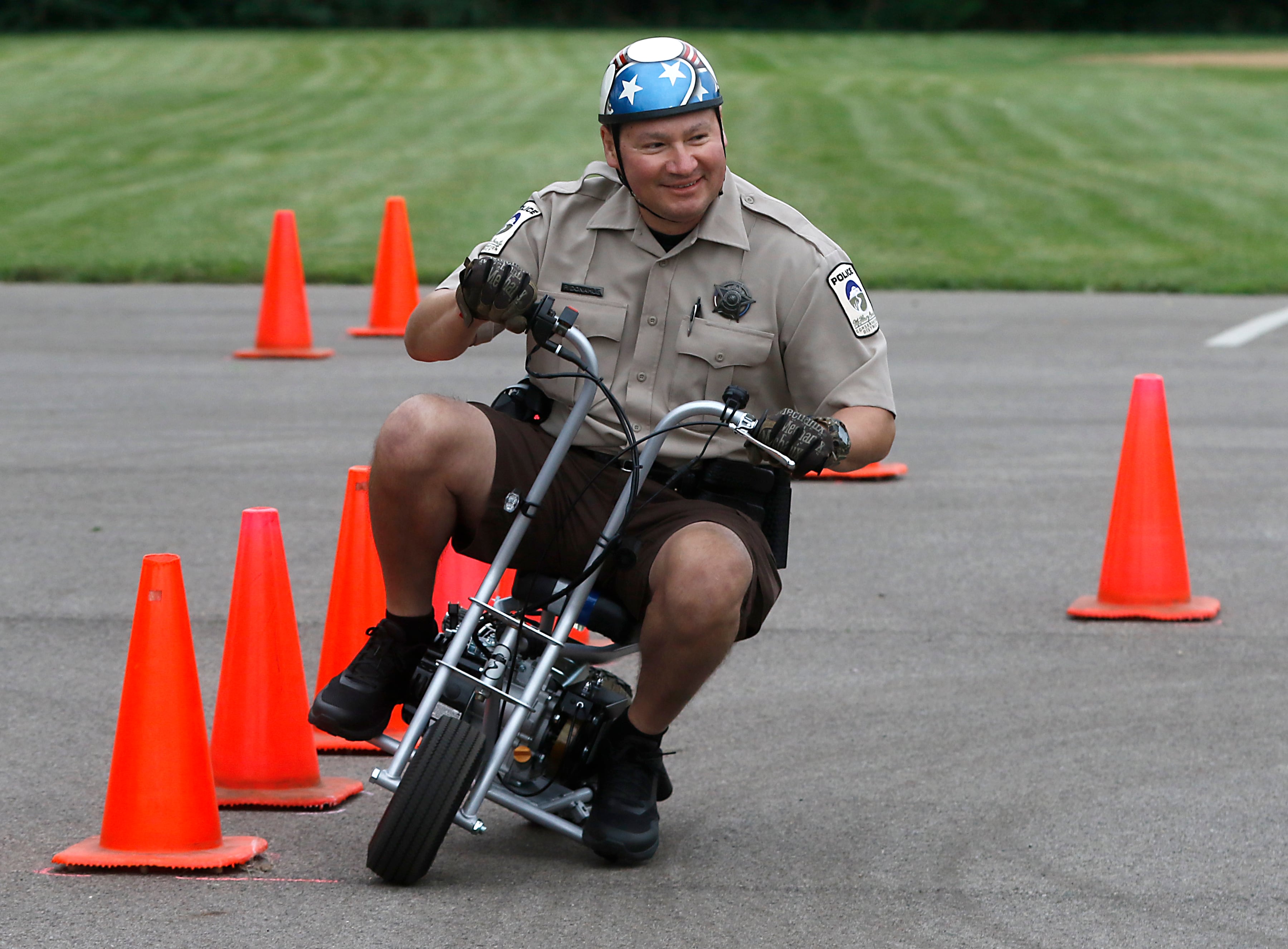 McHenry County Conservation District Police Patrick Donahue rides “Mo” as he has some fun while performing in the motorcycle demonstration during a National Night Out event Tuesday, Aug. 6, 2024, at Petersen Park in McHenry.