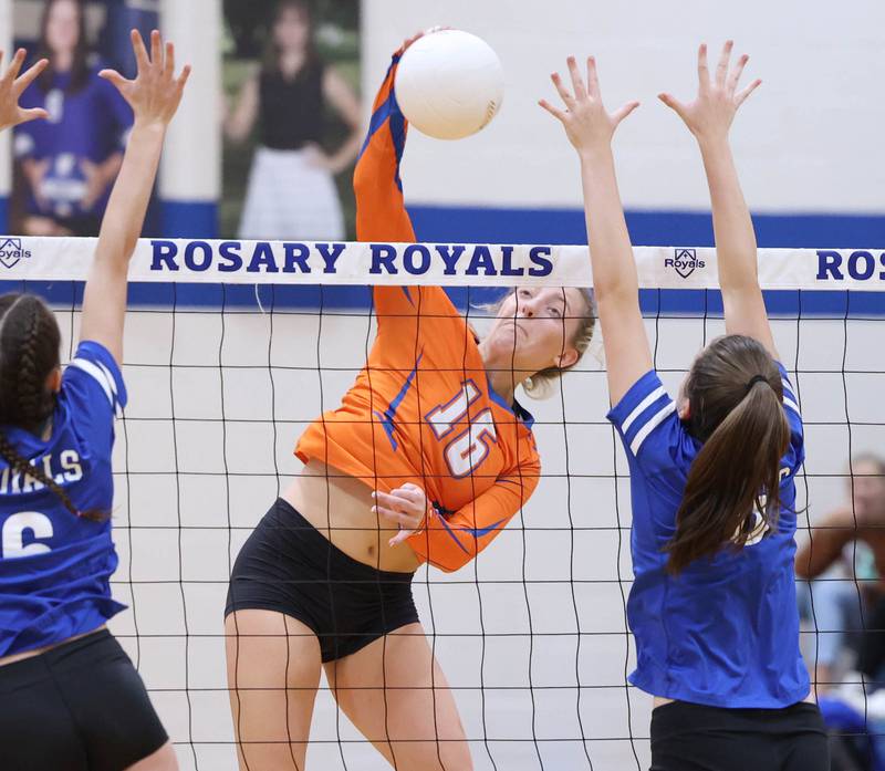 Genoa-Kingston's Alayna Pierce spikes the ball between two Rosary blockers during their Regional semifinal match Tuesday, Oct. 25, 2022, at Rosary High School in Aurora