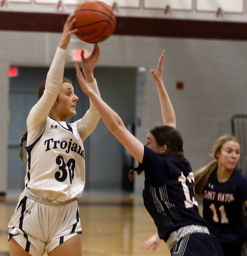 Cary-Grove's Sam Skerl passes the ball to a teammate as she drives the lane against St. Viator's Maeve McClellan during an IHSA Class 3A Antioch Sectional semifinal girls basketball game on Tuesday, Feb. 20, 2024, at Antioch High School.