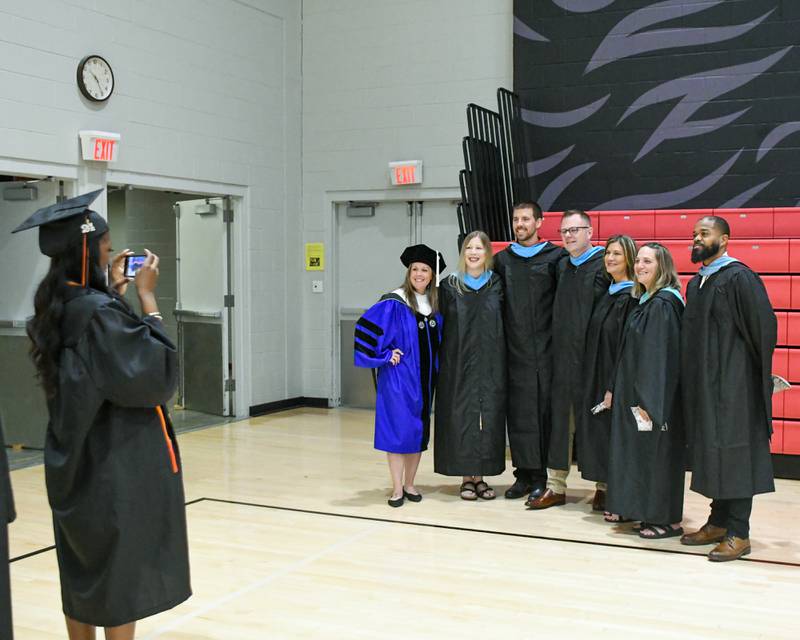 DeKalb High School administrators pose for a photo before the start of the 2024 DeKalb High School commencement ceremony on Saturday, May 25, 2024, at the Northern Illinois University Convocation Center in DeKalb.