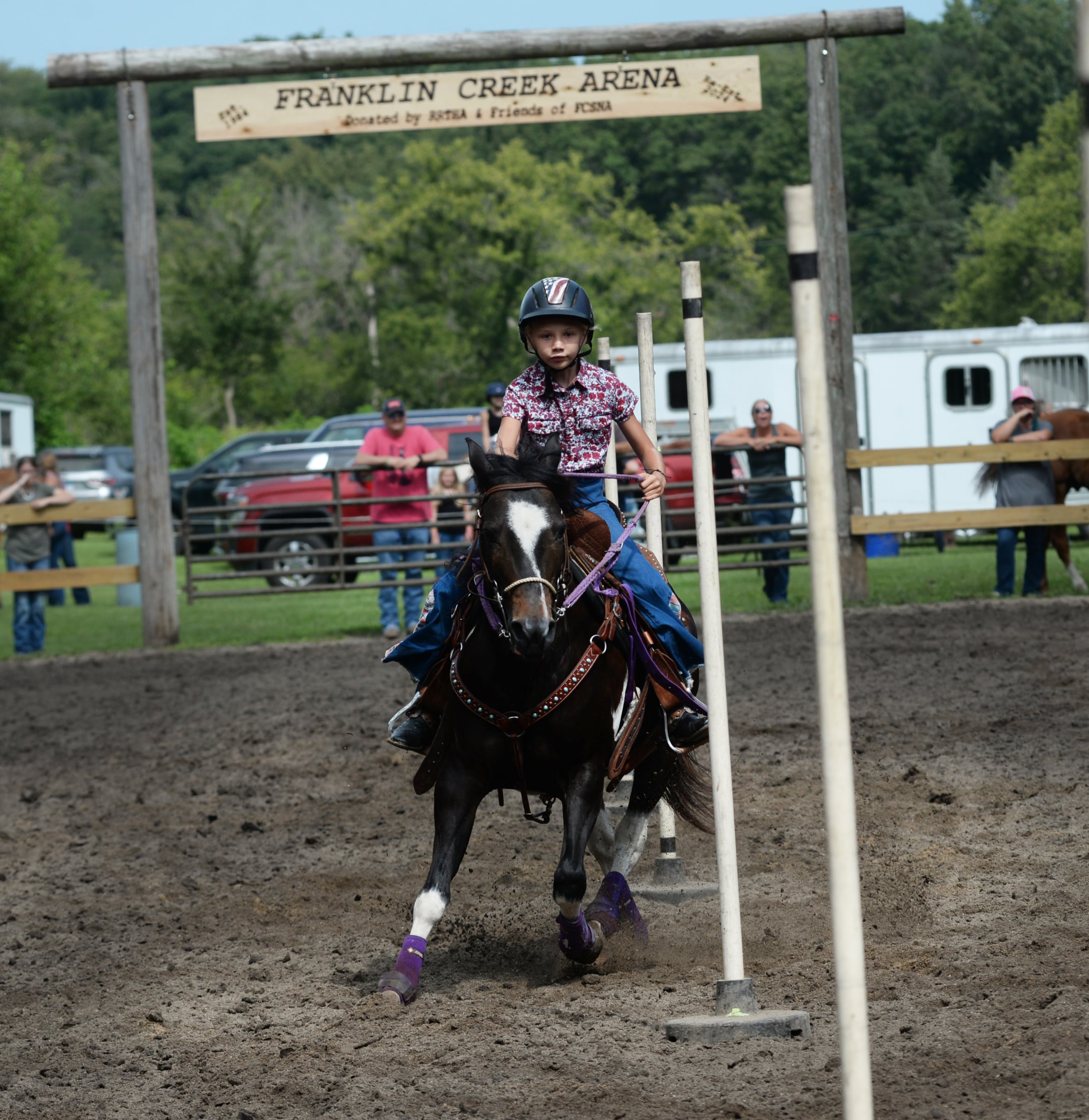 Adessa Hummel, 9, of Dixon, navigates her horse, Missy, through the Poles Competition at the Rock River Trail & Horseman Association's Grand Opening Show on Saturday, July 20, 2024.