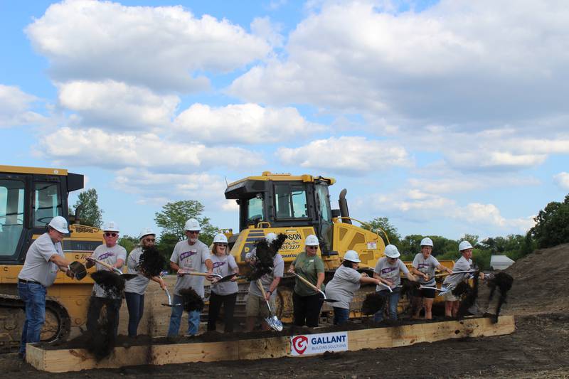 Food Shed Co-Op board members shovel the first mound of dirt at the groundbreaking ceremony in Woodstock on July 18, 2023.
