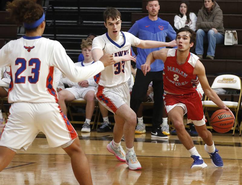 Marian Central's Jake Giangrego drives the baseline against Hoffman Estates’ Adell Bosnjak during a Hinkle Holiday Classic basketball game Tuesday, Dec. 27, 2022, at Jacobs High School in Algonquin.