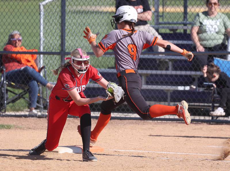 DeKalb's Ayla Baty-Gould is just out as Rockford Auburn's Emmarie Ostergard catches the ball just in time for the force out during their Class 4A regional semifinal game Wednesday, May 22, 2024, at Hampshire High School.