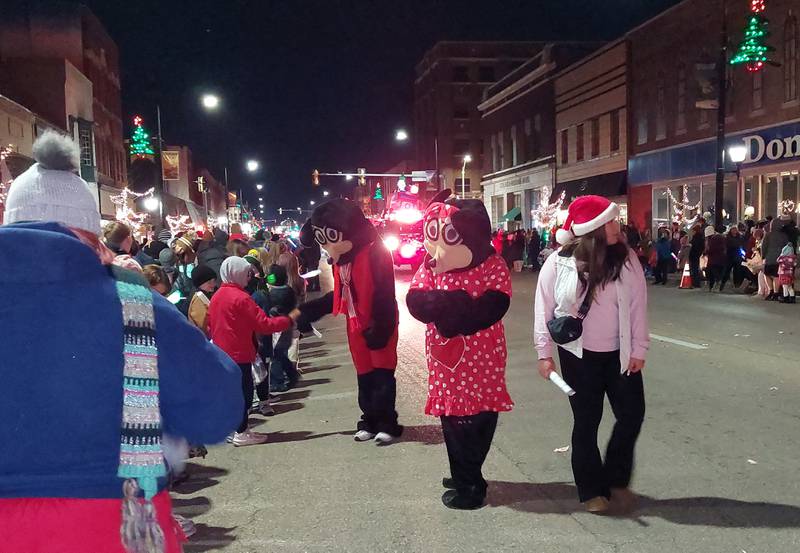 Mickey and Minnie Mouse greet parade goers Saturday, Nov. 25, 2023, on Main Street during the Streator Lighted Christmas Parade.