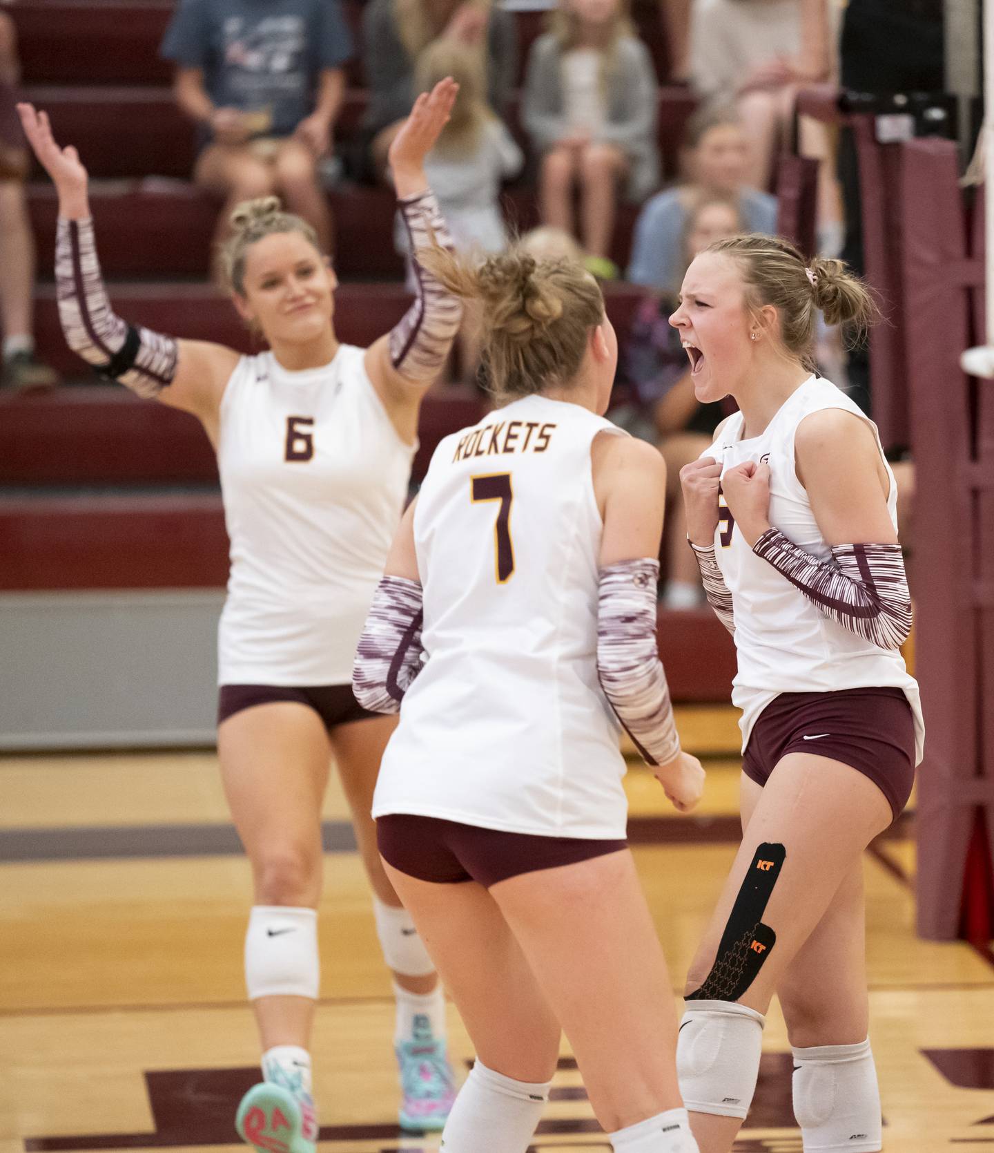 Richmond-Burton's Reagan Wisniewski, right, celebrates a point against Johnsburg with teammates Elissa Furlan, 6, and Alexandra Hopp, 7, during their game on Monday, August 26, 2024 at Richmond-Burton High School in Richmond.