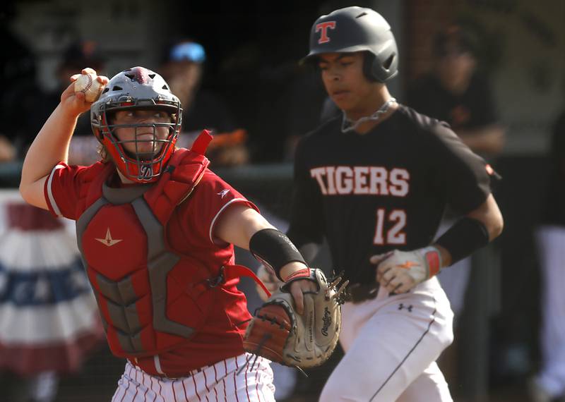 Deerfield's Ethan Platt throws to first base to turn a double play as Crystal Lake Central's Jaden Obaldo runs home during a Class 3A Grayslake Central sectional championship baseball game on Friday, May 31, 2024, at the Grayslake Central High School.