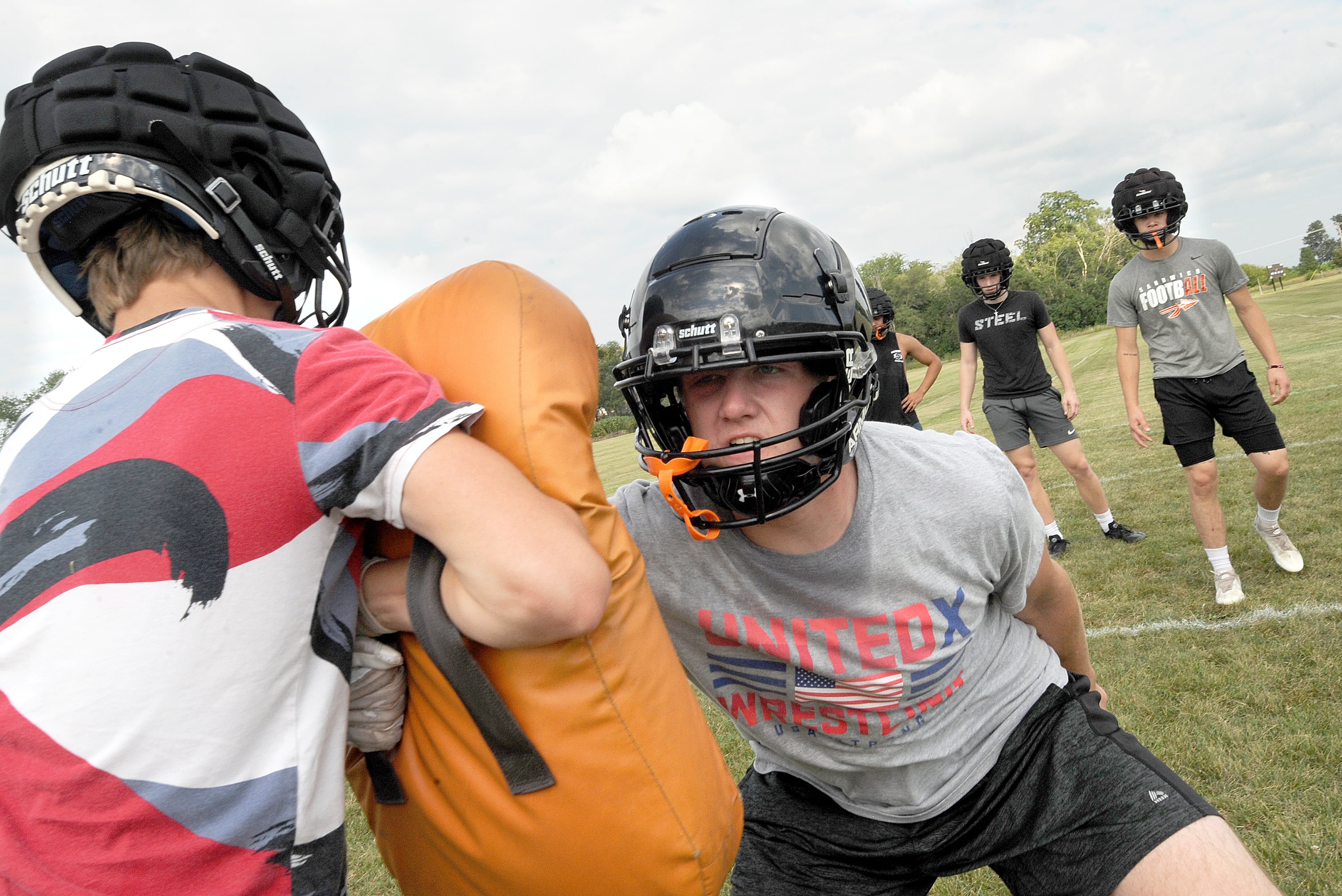 Sandwich football player Kaden Clevenger hits a bag and sheds the blocker during linebacker drills on the first day of football practice at Sandwich High School on Monday, Aug. 12, 2024.