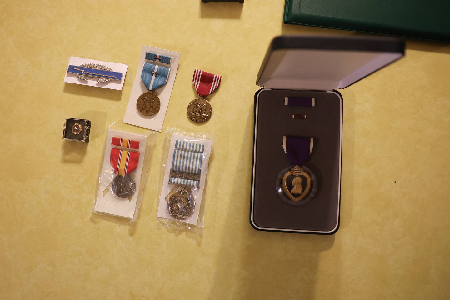 PFC Bryan Myers Jr.’s medal, including his Purple Heart sit on the counter of his sister Barbara Lee Cerney at her home in Shorewood on Friday, May 24, 2024. PFC Bryan Myers Jr.’s remains were recently returned to family after being kill in Korea in 1950.