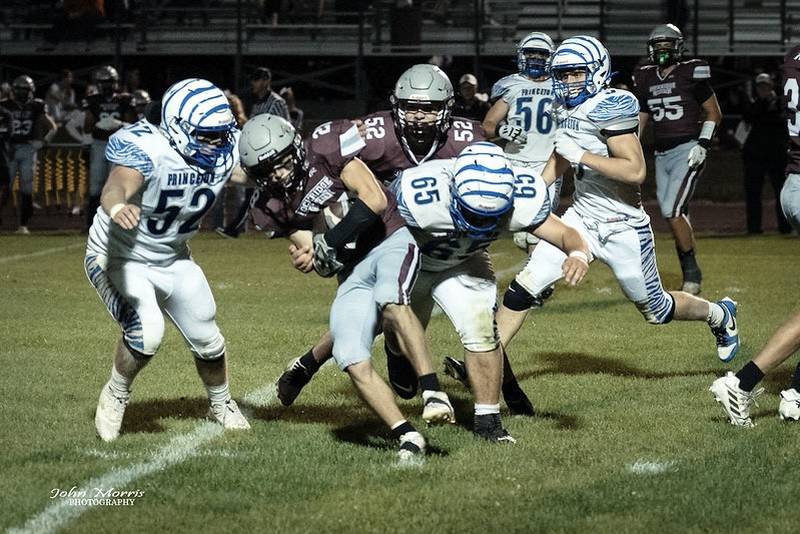 Princeton's Ian Morris (52) and Cade Odell (65) make the stop on Rockridge's Jacob. Freyermuth Friday night. The Tigers won 27-18.