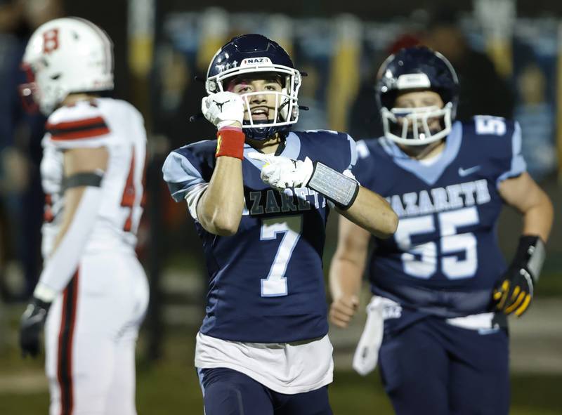 Nazareth's Jake Cestone (7) points to a wristband honoring a family friend who died from cancer after scoring a touchdown during the varsity football game between Benet and Nazareth academies on Friday, Oct. 18, 2024 in La Grange Park.