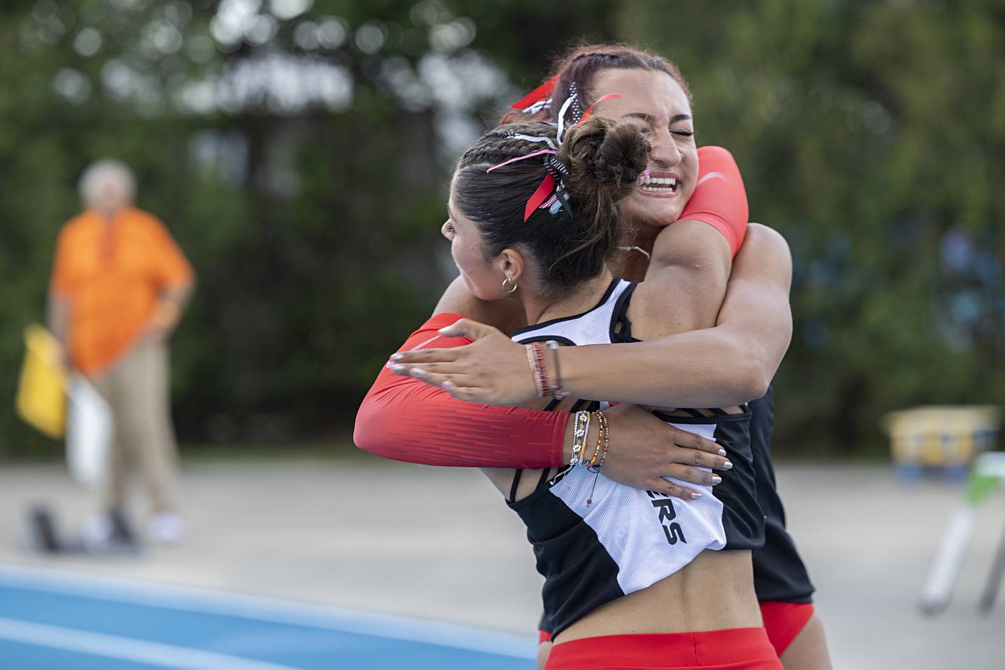 Huntley’s Victoria Evtimov (left) and Sophie Amin share a hug after winning the 3A 4x100 Saturday, May 18, 2024 at the IHSA girls state track meet in Charleston.