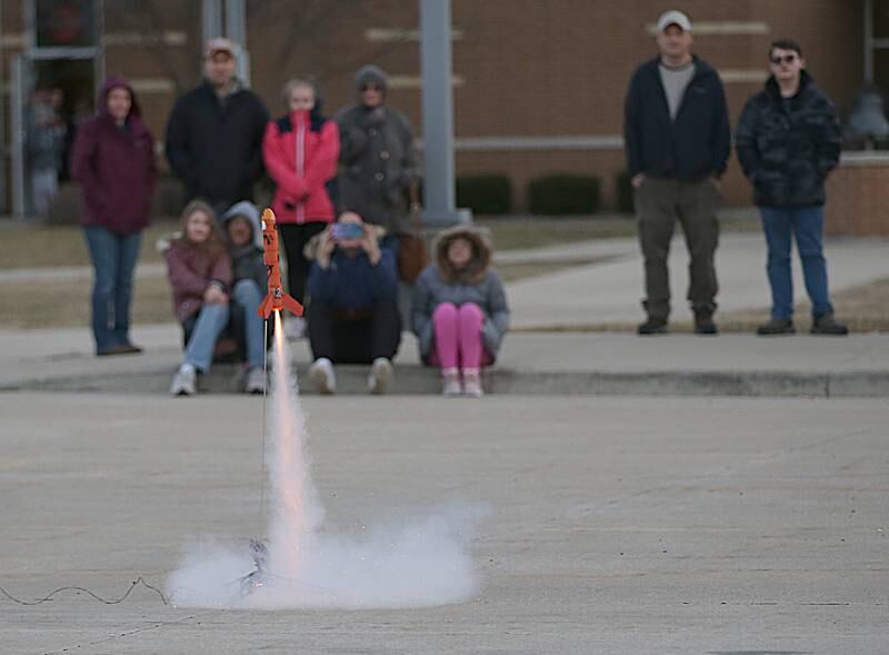 A rocket launches outside during STEM Family Night on Tuesday, March 7, 2023 at Central and Shepherd School in Ottawa.