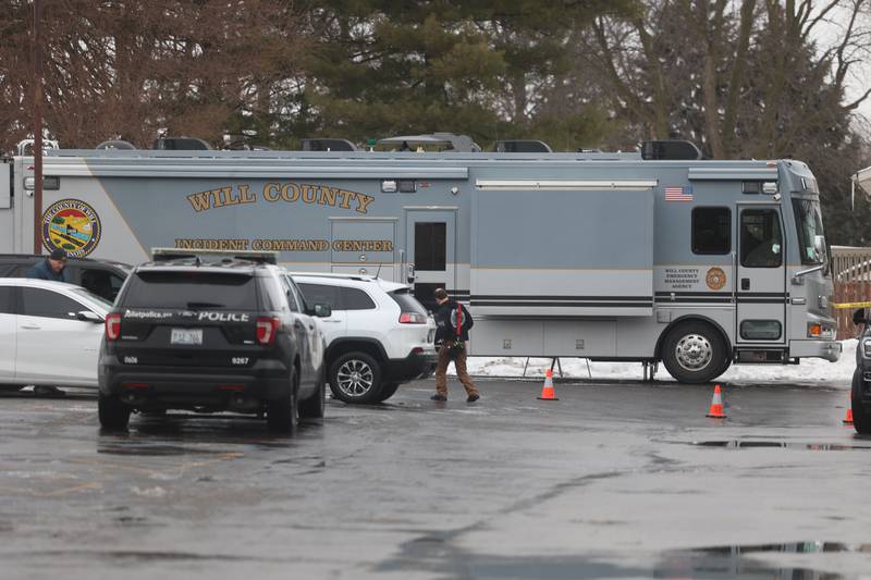 A Will County Incident Command Center vehicle sits in a parking lot along West Acres Road at the scene were multiple people were found dead in two homes on Monday, Jan. 22nd in Joliet.