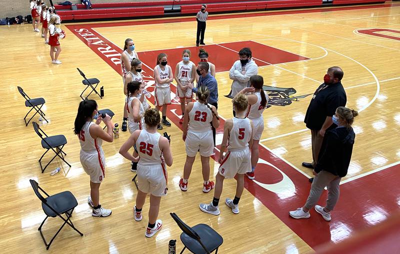 Ottawa girls basketball coach Brent Moore (at center) talks things over with his Lady Pirates during a quarter break Friday, Feb. 19, 2021.