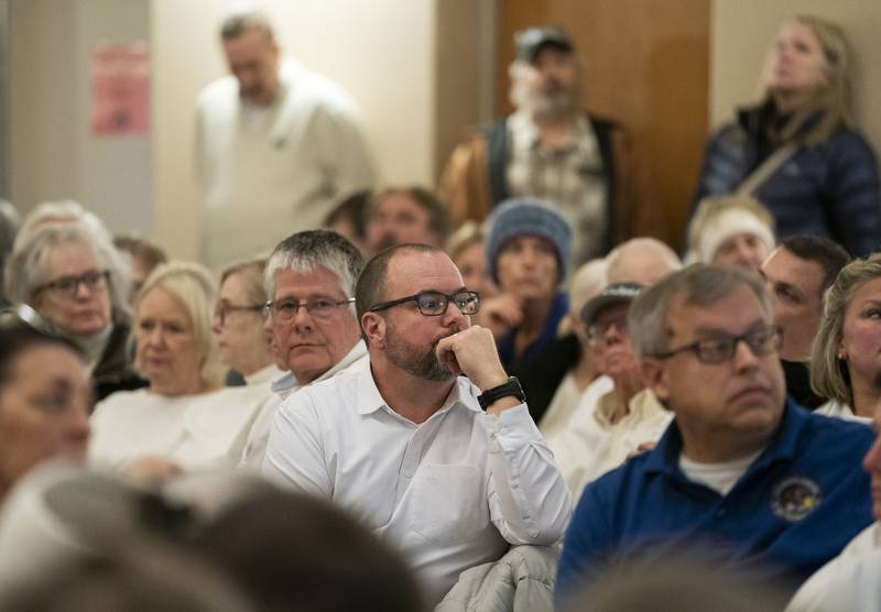 Concerned nearby reisdent Kevin McVearry, center, listens to a presentation during a Planning and Zoning meeting at Crystal Lake City Hall on Wednesday, January 24, 2024. Crystal Lake trucking company NVA Transportation is seeking a rezoning of their Sands Road property to expand the business . Ryan Rayburn for Shaw Local