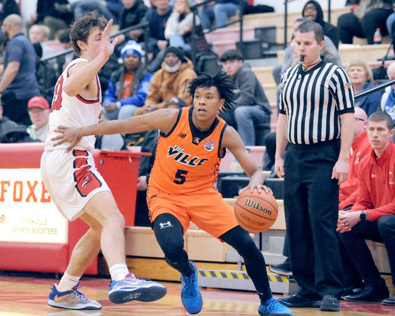 Romeoville's Ej Mosley, Jr. (5) pushes past a Yorkville defender during a varsity basketball game at Yorkville High School on Friday, Jan. 19, 2024.