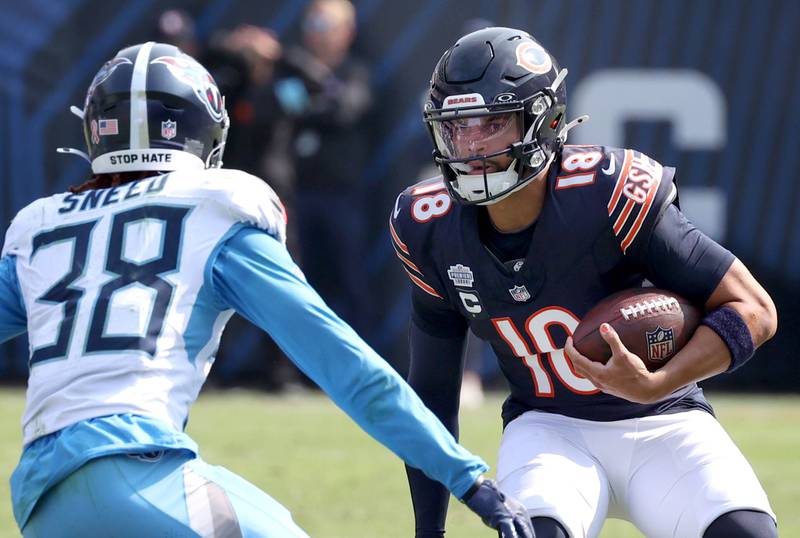 Chicago Bears quarterback Caleb Williams looks to get by Tennessee Titans cornerback L'Jarius Sneed during their game Sunday, Sept. 8, 2024, at Soldier Field in Chicago.