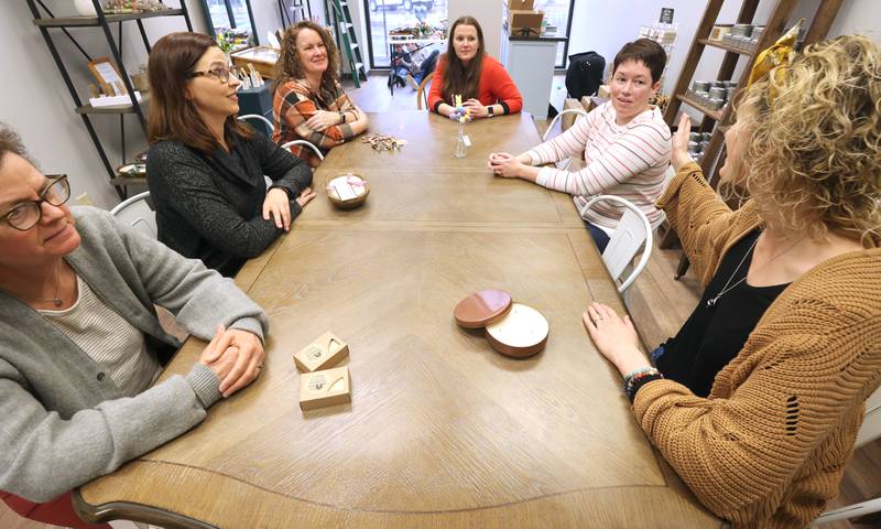 Joni Peterson, (second from right) owner of 35:35 Makers Collective, talks Friday, March 18, 2022, to local artisans who will have their work available for purchase in the shop. The store, at 308 West State Street in Sycamore, is scheduled to open April 1.