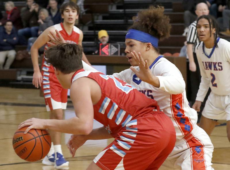 Marian Central's Christian Bentancur tries to drive against Hoffman Estates’ Nate Cleveland during a Hinkle Holiday Classic basketball game Tuesday, Dec. 27, 2022, at Jacobs High School in Algonquin.