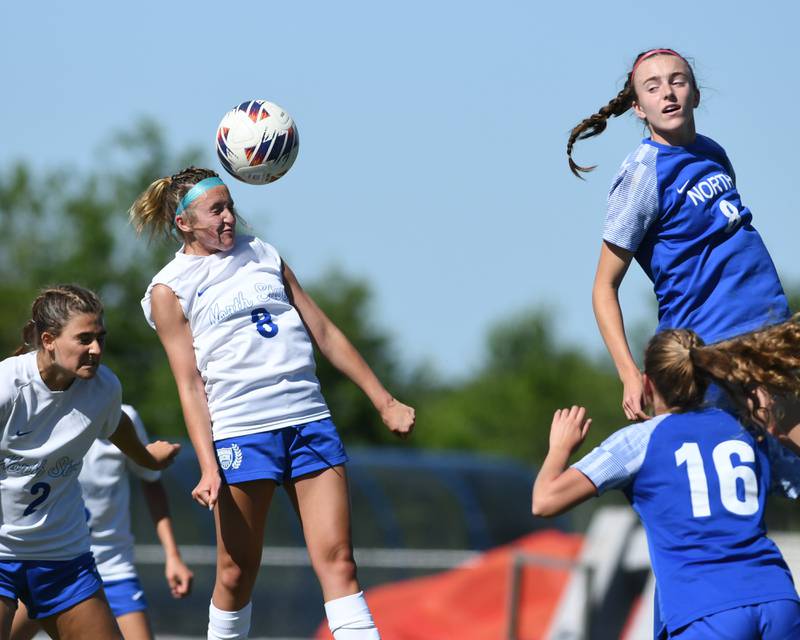 Wheaton North's Jane Rogers (8) and St. Charles North's Keira Kelly (8) along with teammate Kayla Floyd (2) go up for a header during the sectional title game held at South Elgin High School on Saturday May 25, 2024.