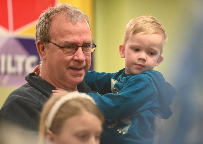 John Wenzelman of Algonquin helps his grandson Liam, 3, get a great view of a model train display Sunday, April 2, 2023, during the Northern Illinois Lego Train Club's expo at the Fox River Valley Public Library in East Dundee. "He loves trains and he loves Legos," Wenzelman said of Liam.