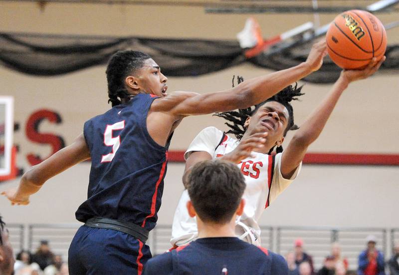 Yorkville's Michael Dunn has a shot blocked by West Aurora defender Terrence Smith (5) during a class 4A regional semifinal basketball game at Yorkville High School on Wednesday, Feb. 21, 2024.