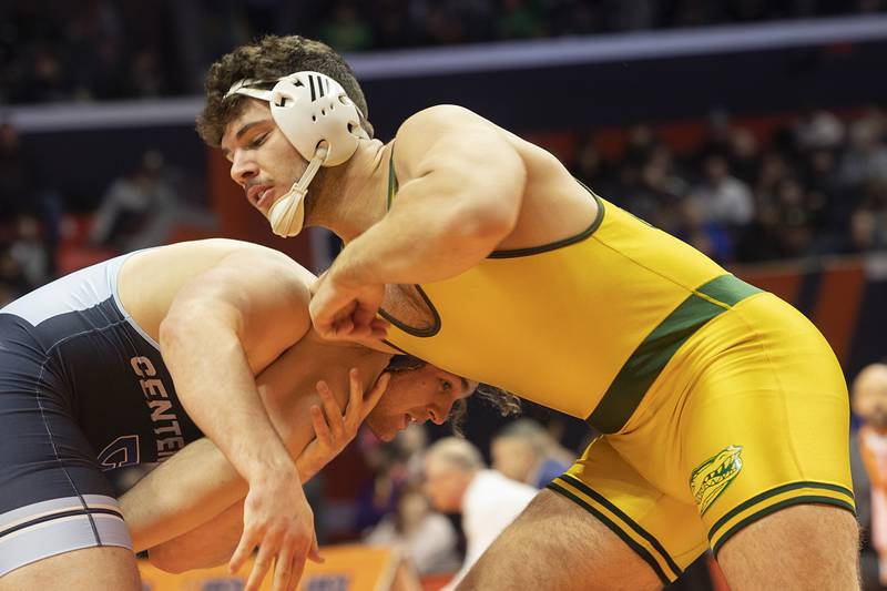 Crystal Lake South’s Andy Burburija (right) and Centennial’s Jack Barnhart go for the title in the 2A 285 pound championship match Saturday, Feb. 17, 2024 at the IHSA state wrestling finals at the State Farm Center in Champaign.