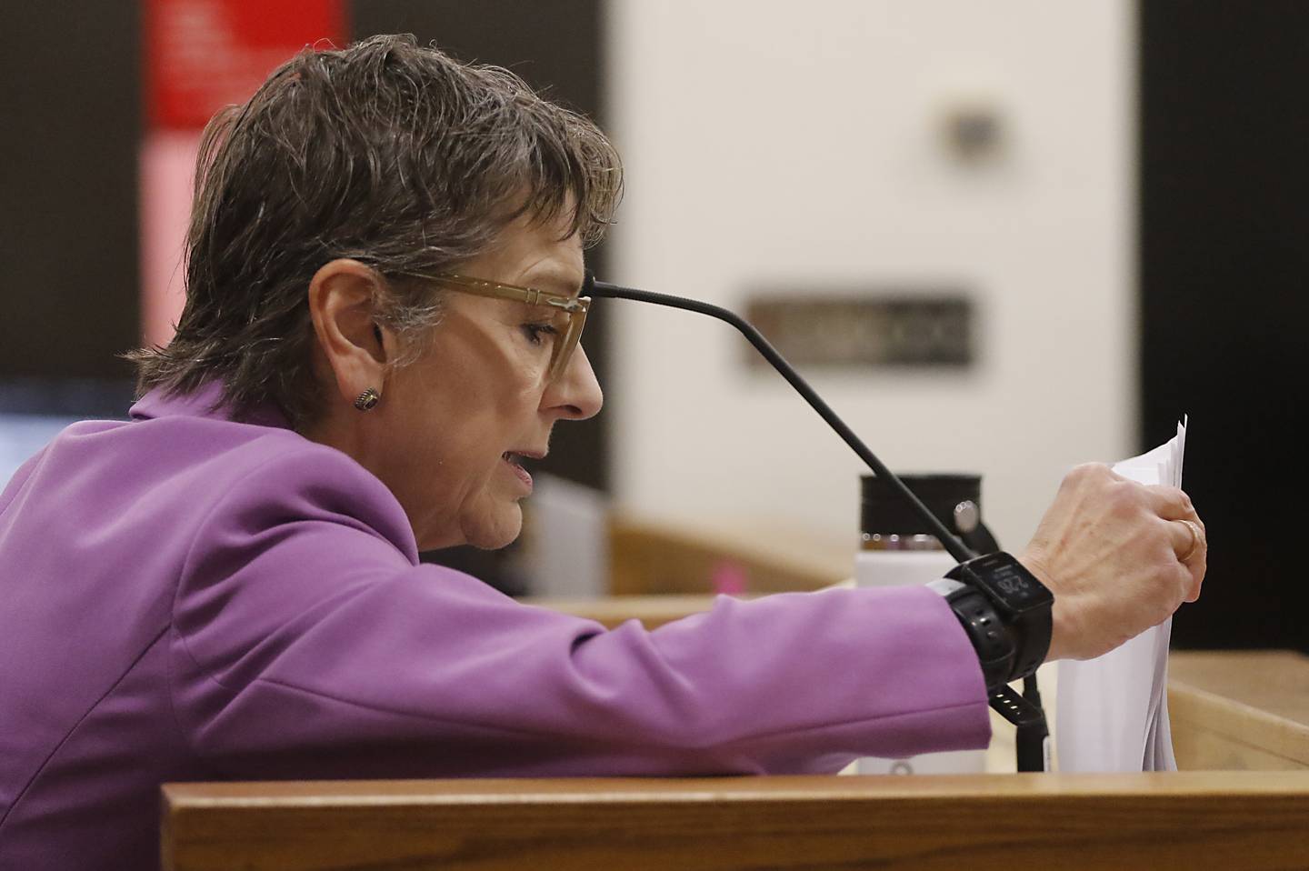 Witness Dr. Lindsey Thomas looks over an autopsy report as she answers a question during Linda La Roche’s hearing for a new trial on Feb. 26, 2024. La Roche was found guilty in 2022 for the murder of Peggy Lynn Johnson-Schroeder in 1999 and for concealing her corpse. La Roche was sentenced to life in prison without parole for the murder, and a consecutive five year sentence on the concealing a corpse charge. Johnson-Schroeder was known as Jane Doe until her identity was discovered when LaRoche was named as the suspect in the case.
