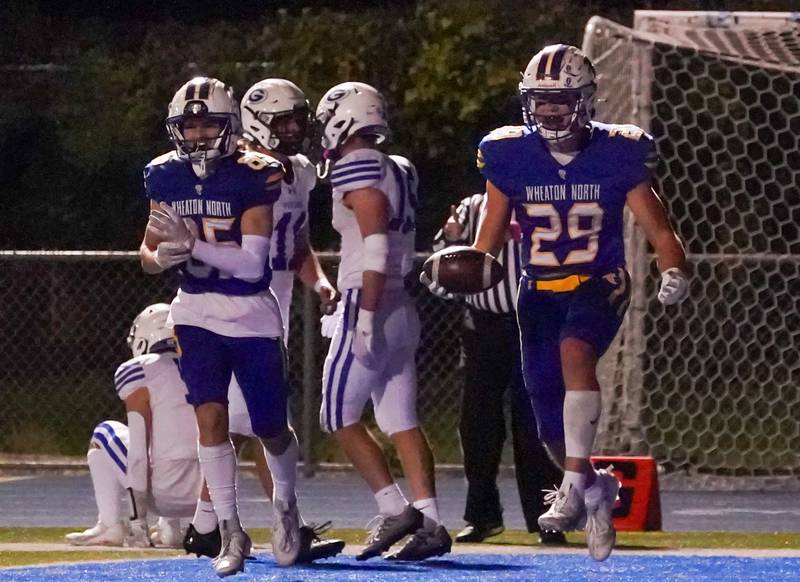 Wheaton North's Walker Owens (29) celebrates after scoring a touchdown against Geneva during a football game at Wheaton North High School on Friday, Oct. 6, 2023.