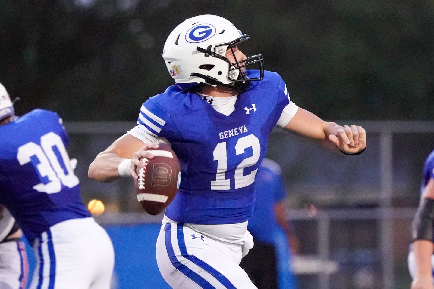 Geneva’s Anthony Chahino (12) rolls out of the pocket and looks downfield for a pass against Larkin during a football game at Geneva High School on Friday, Aug 30, 2024.