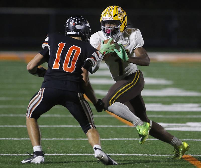 Jacobs' Tyvon Boddie tries to run against McHenry's Owen Hobson during a Fox Valley Conference football game on Friday, Oct. 18, 2024, at McKracken Field in McHenry.