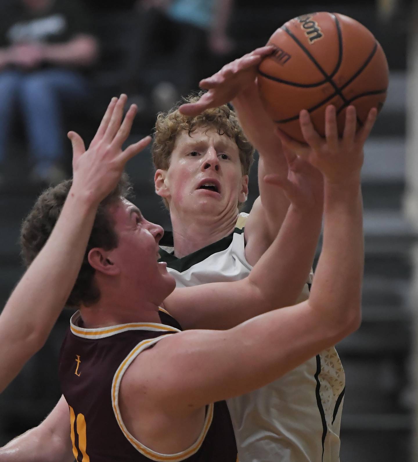 St. Edward’s Kaden Dawson tries to block the shot of Montini’s Jake Maquet in a boys basketball game in Elgin on Thursday, Jan. 4, 2023.