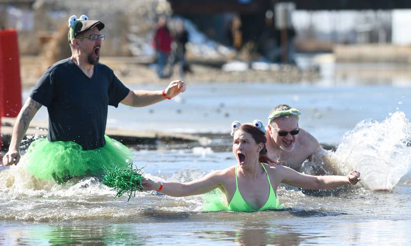 Rick West/rwest@dailyherald.com
Sara Lorenzo of Lindenhurst reacts after jumping in to the 34 degree water of Nippersink Lake during the Fox Lake Polar Plunge for Special Olympics Sunday. Plunging with her were Rob Zando of Spring Grove, left,  and Rob Blaire of Crystal Lake.