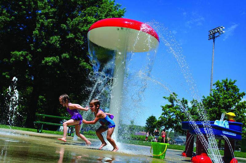 Kids get a good drenching Wednesday in the curtain of water cascading from the dew drop at Vaile Park in Dixon.