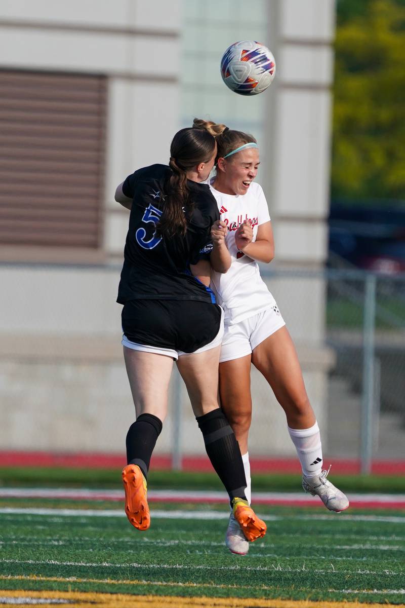 St. Charles North's Rian Spaulding (5) and Batavia's Emma Stoodley (3) collide while trying to head the ball during a Class 3A Batavia Regional final soccer match at Batavia High School in Batavia on Friday, May 17, 2024.