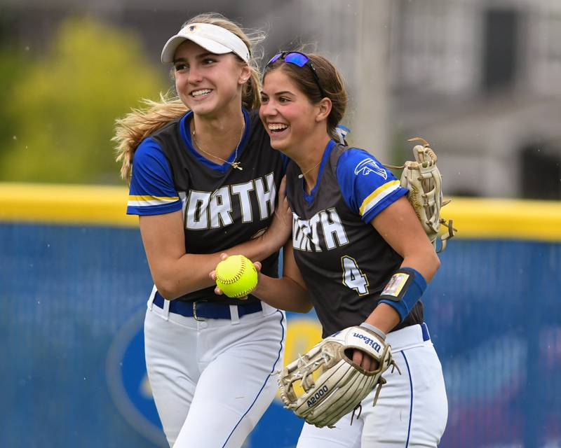 Wheaton North's Makayla Grantz (4) gets congratulated by teammate Makayla Hammer after Makayla Grantz dove to catch the ball during the game against Glenbard North on Monday May 13, 2024, held at Wheaton North.