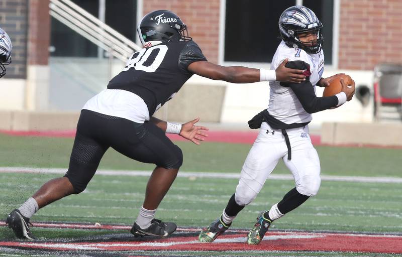 Kankakee's Tomele Staples escapes the rush of Fenwick's Nathaniel Marshall during the Class 5A state championship Saturday, Nov. 27, 2021, in Huskie Stadium at Northern Illinois University in DeKalb.