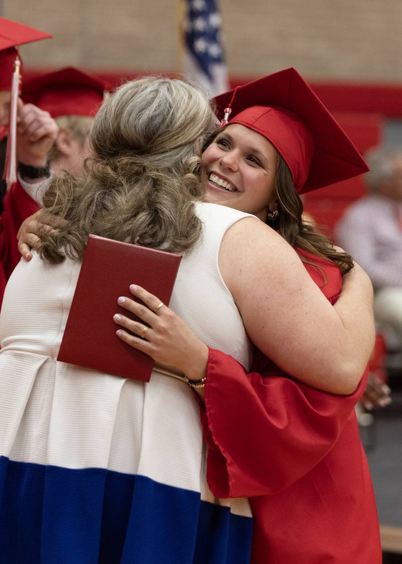 Kendall Lowery hugs a faculty member after receiving her diploma Friday, May 24, 2024, at Kingman Gym.
