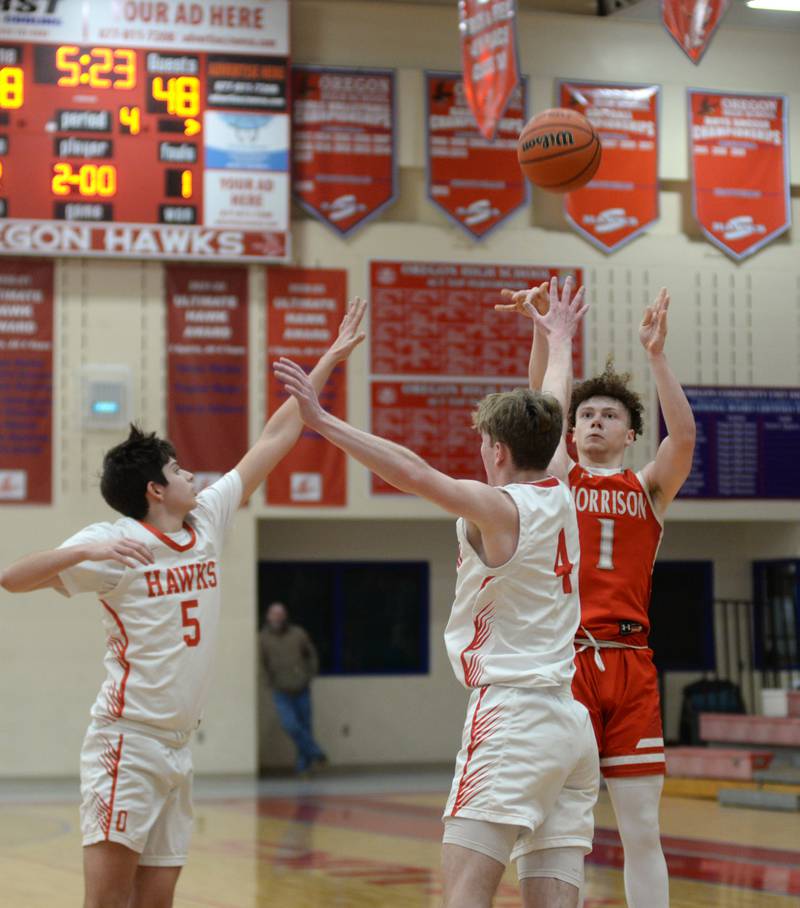 Morrison's Dawson Hepner (1) shoots as Oregon's Jameson Caposey (4) and Nole Campos (5) defend during 2A regional action on Monday, Feb. 19, 2024 at the Blackhawk Center in Oregon. The Mustangs downed the Hawks 59-52 to advance to the Prophetstown Regional on Wednesday, Feb. 21.